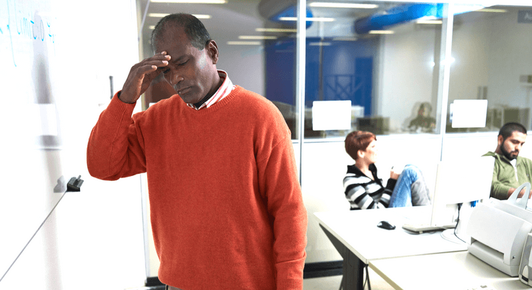 A man with with his hand to his forehead looking concerned