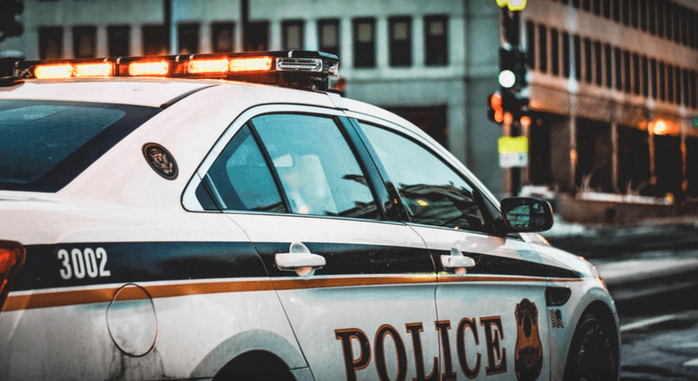 Police car driving down a city street