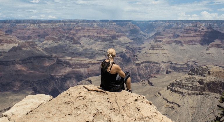 Female hiker sitting on a cliff