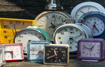 A table with containing clocks in many sizes and colors
