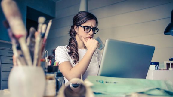 Worried young woman using a laptop