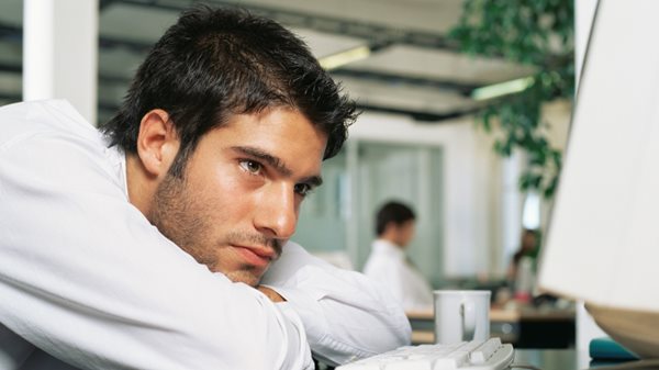 Bored man at computer monitor