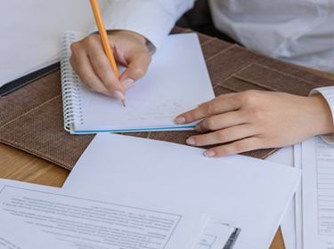 Person hand writing a job description