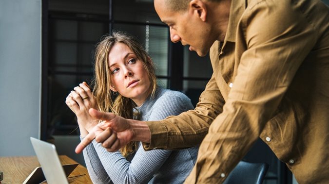 Man and woman sitting at a desk at work